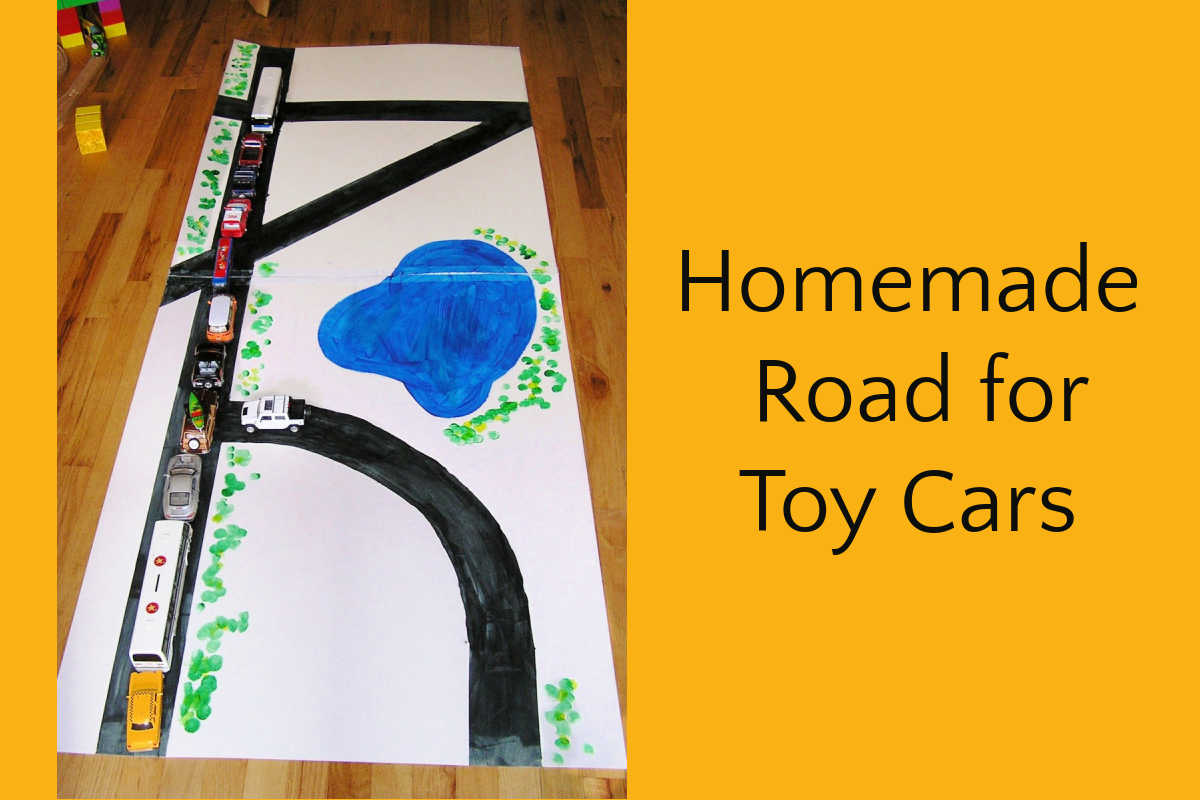 DIY road for toy cars made from large, painted matte board