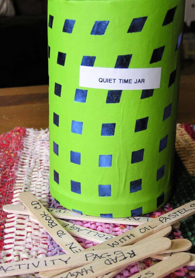Green covered jar labeled "quiet time jar" with craft sticks and activity ideas