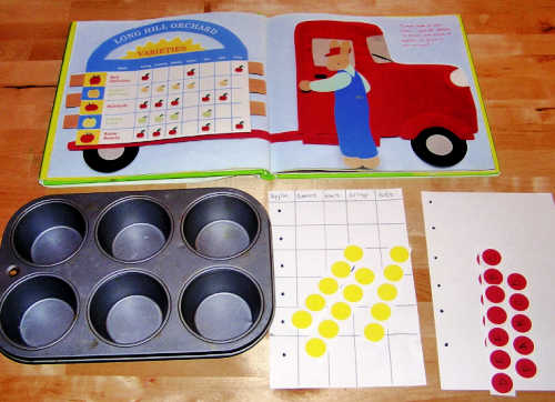 Open books with empty muffin tin, grid and office supply stickers