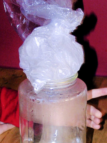 Water in glass jar topped by bag of ice