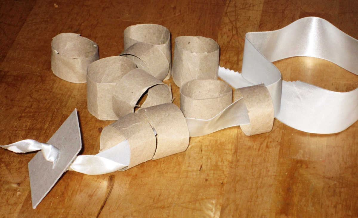 Lacing ribbon and paper rolls for toddler activity