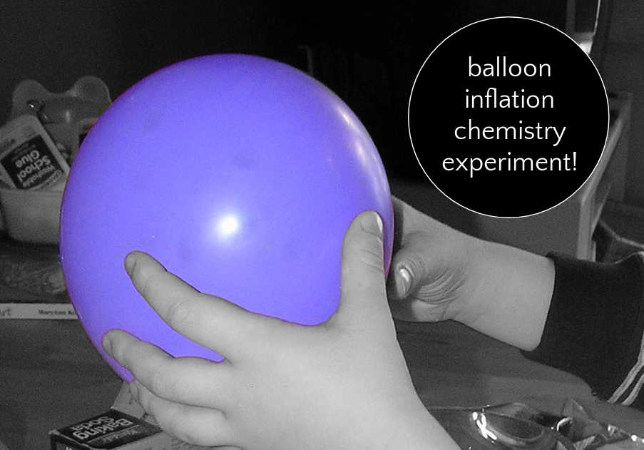 Child holding inflated purple balloon