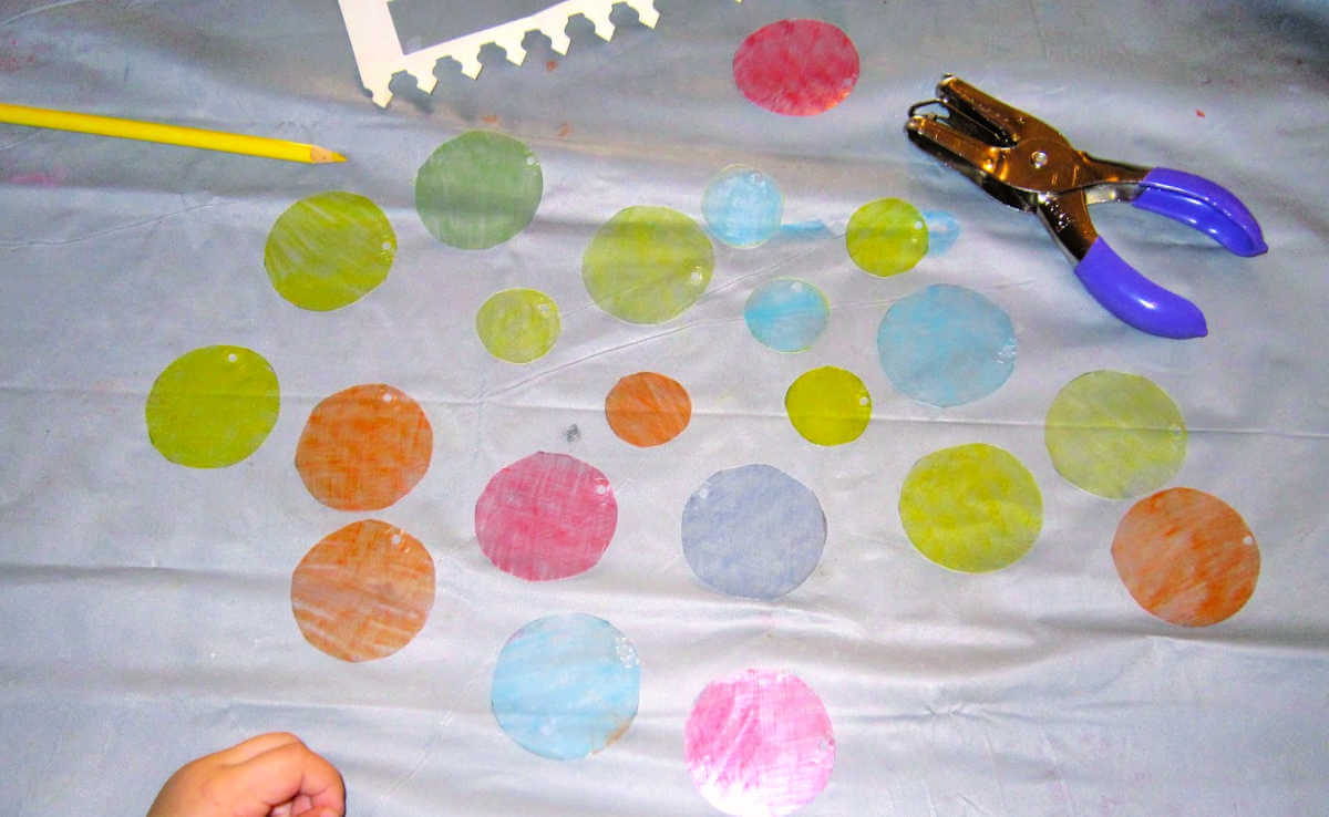 Colorful circles of shrink plastic sheets on gray mat