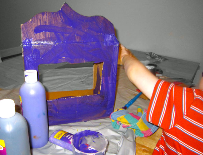 Painting the diy cardboard puppet theater purple