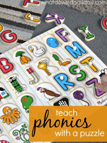 Partially completed wooden alphabet puzzle on rug with text overlay "teach phonics with a puzzle".
