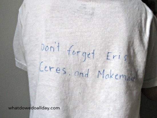 Back of t-shirt that says, "Don't forget Eris, Ceres, and Makemake."