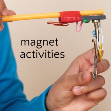 Child playing with magnet wand and paperclips