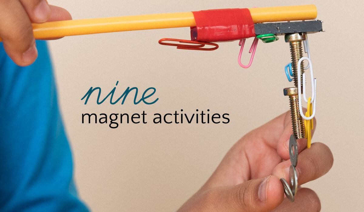 Child playing with magnet wand and paperclips