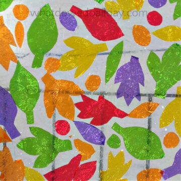 Colorful cellophane cut into leaves and dots and applied on a window.
