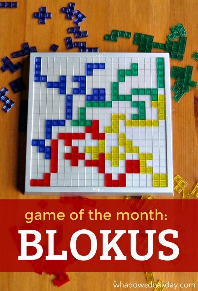 Blokus game in play on table. Text on image reads "Game of the Month: Blokus"
