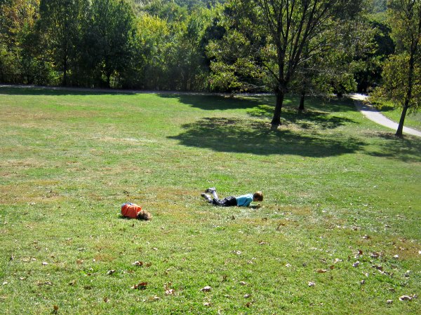 Classic outdoor activity for kids: rolling down the hill.