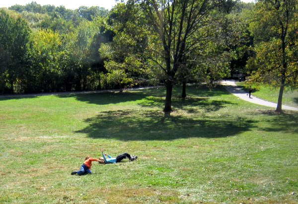 Classic outdoor activity for kids: rolling down the hill.