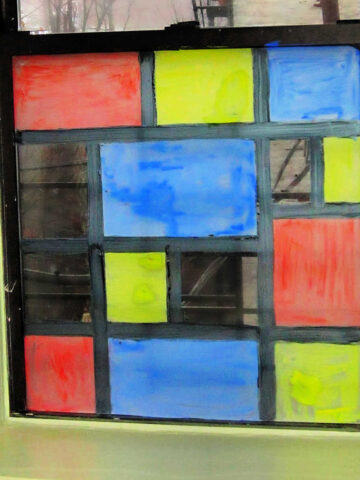 Window painted in style of Mondrian art.