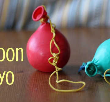Two balloon yo-yos on a table.