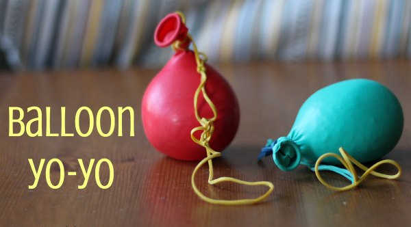 Two balloon yo-yos on a table.