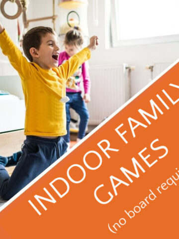 Child raising arms in victory for indoor family games.