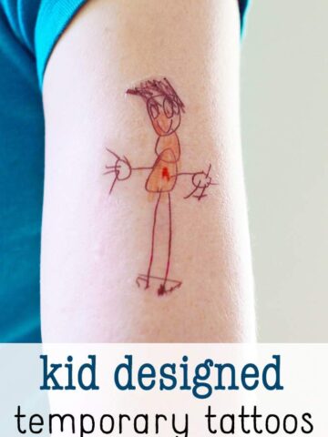 Arm with temporary tattoo of child-drawn art.