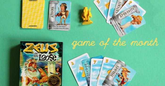 Family card game Zeus on the Loose showing cards fanned out, box and yellow Zeus figurine