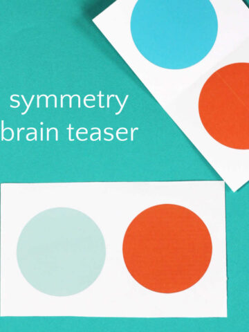 Two pieces of paper, each with one large orange and one large blue dots.