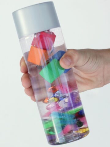 Fun science at home with a sink or float science discovery bottle for kids.