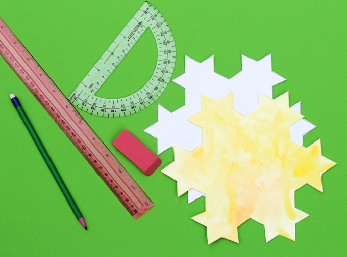 Paper Koch snowflake with ruler, pencil and eraser