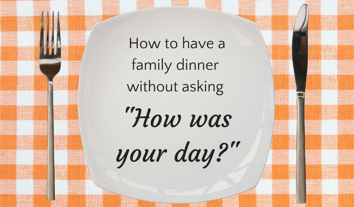White plate on orange checked tablecloth with fork and knife, with text inside plate that reads "how to have a family dinner without asking how was your day?"