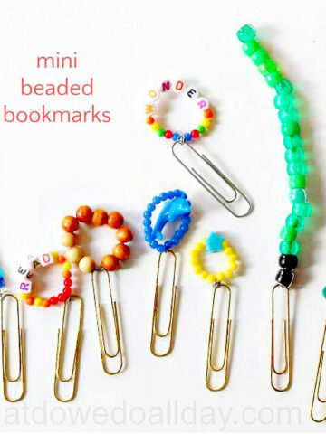 Collection of mini beaded bookmarks made from rings of beads on wire attached to paperclips.