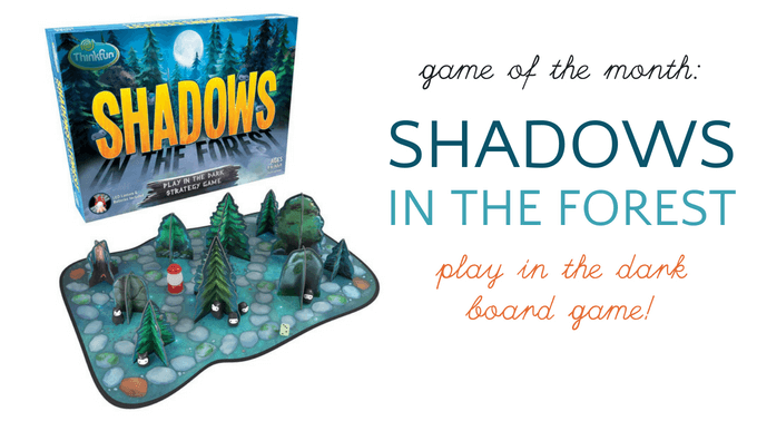 Shadows in the Forest board game, box and board with tree shaped and lantern tokens.