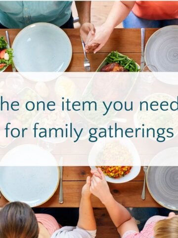 Family holding hands at dinner table with text overlay, "the one item you need for family gatherings."