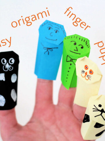 Five origami finger puppets on a hand.
