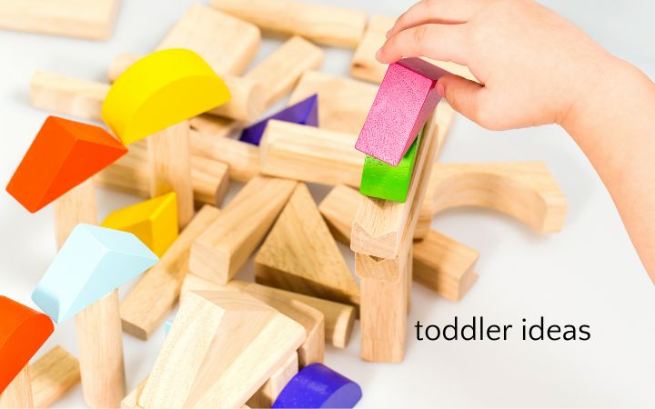 Toddler hand playing with unit blocks independently