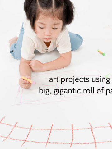 Child drawing on big piece of paper