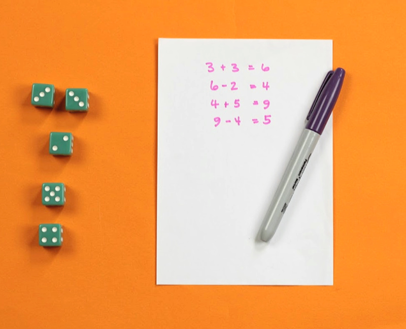 5 green dice and score sheet for addition and subtraction dice game