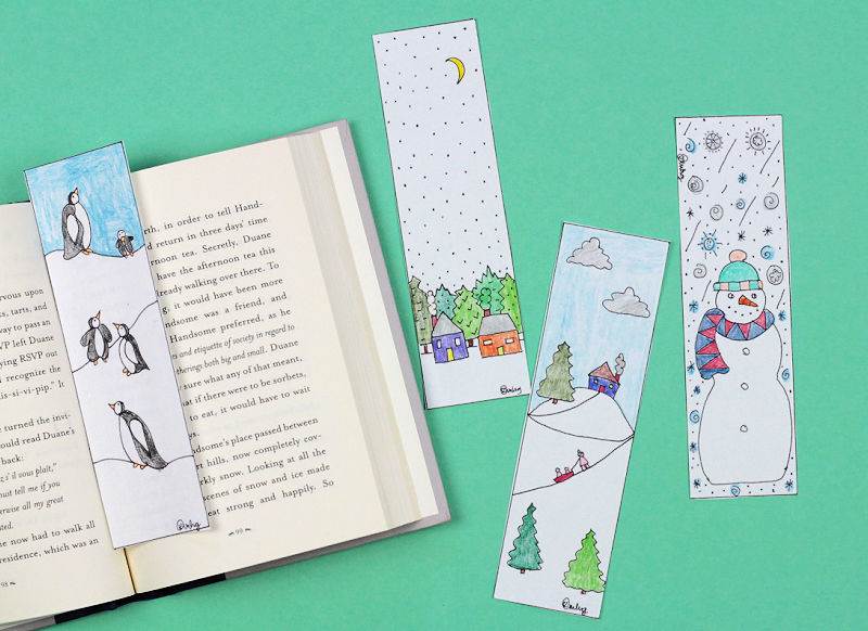 Winter scene bookmarks and open book on green background