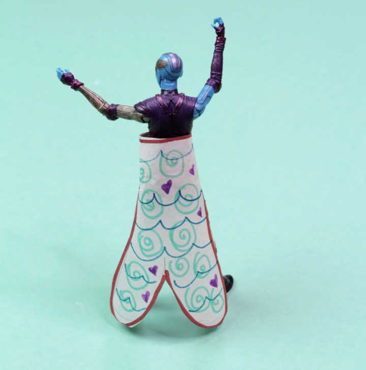 Action figure wearing paper diy mermaid tail.