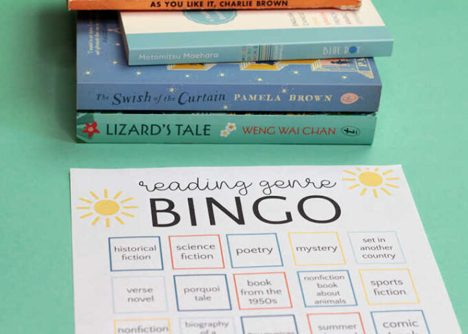 stack of books and summer reading bingo card