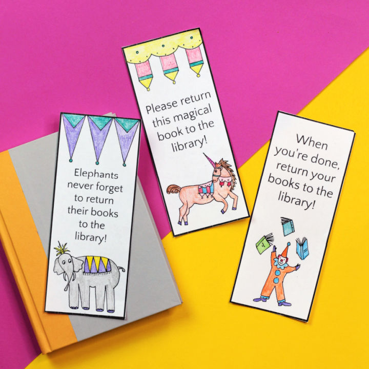 Three circus bookmarks and book on pink and yellow background