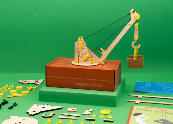 wooded crane science project with pieces and sitting on orange tinker crate box