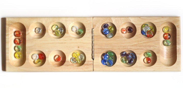 wooden Mancala board with marbles