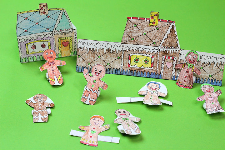 Two sets of finished gingerbread houses and gingerbread people finger puppets