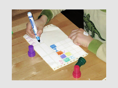 Child coloring in white sticker labels