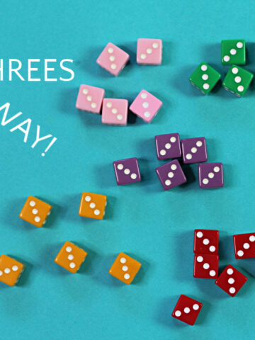 Five sets of colored dice for the game threes away