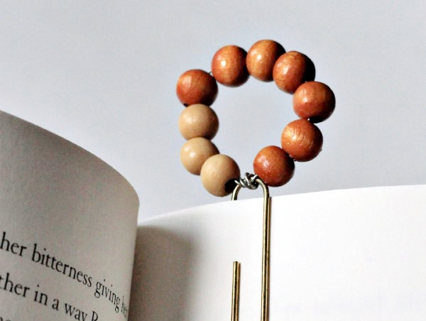 wood bead paper clip bookmark attached to book page