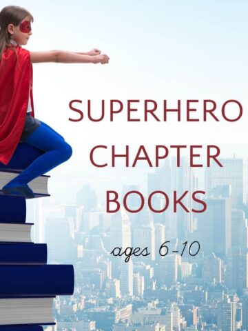 Superhero girl sitting on stack of books in front of a cityscape