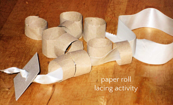 Homemade lacing activity with paper roll and ribbon