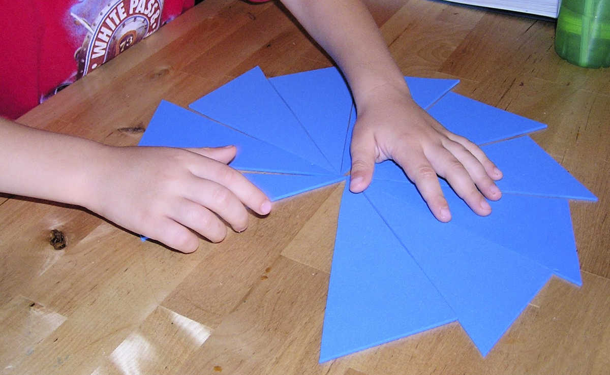 Child playing with blue Montessori scalene triangles