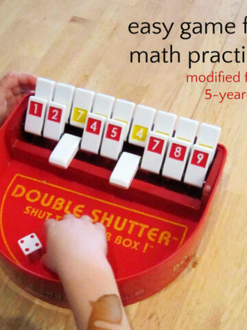 Child playing Double Shutter with text, easy game for math practice modified for a 5-year-old.