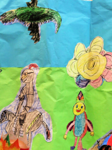 Child's drawings cut out on blue and green background to use in pretend play scape.