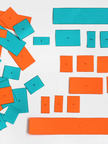 Blue and orange paper cut into fraction sizes.