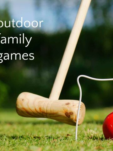 Plain wooden croquet mallet aiming at red ball under white wire wicket, with text overlay "outdoor family games."